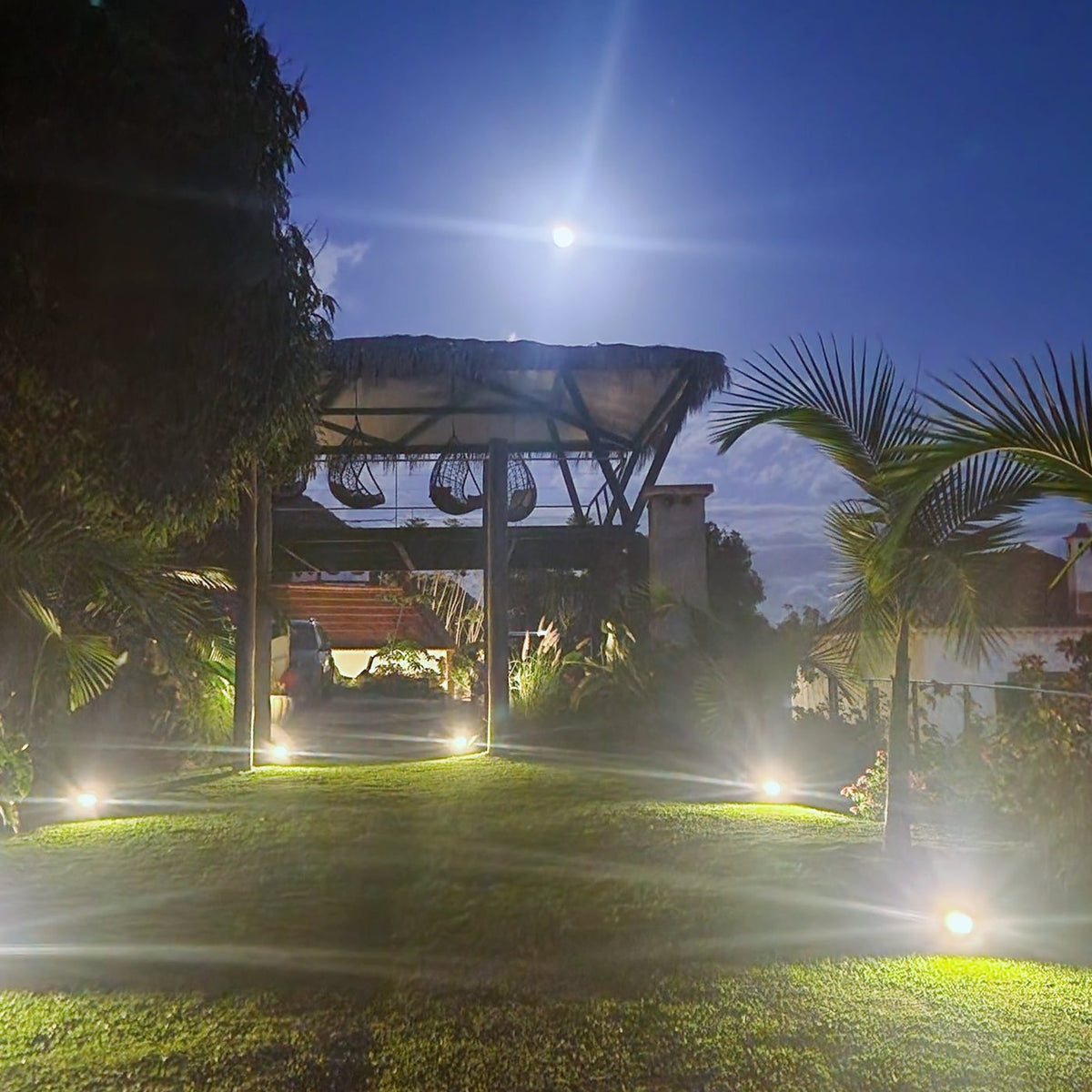 The gardens lit at night under the full moon