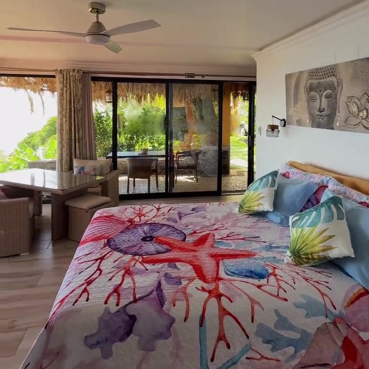 The double bed with sliding glass doors open to the garden and the terrace